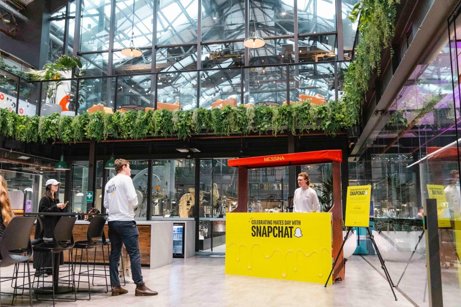 Large gelato stand with a bright yellow Snapchat panel in a glass atrium