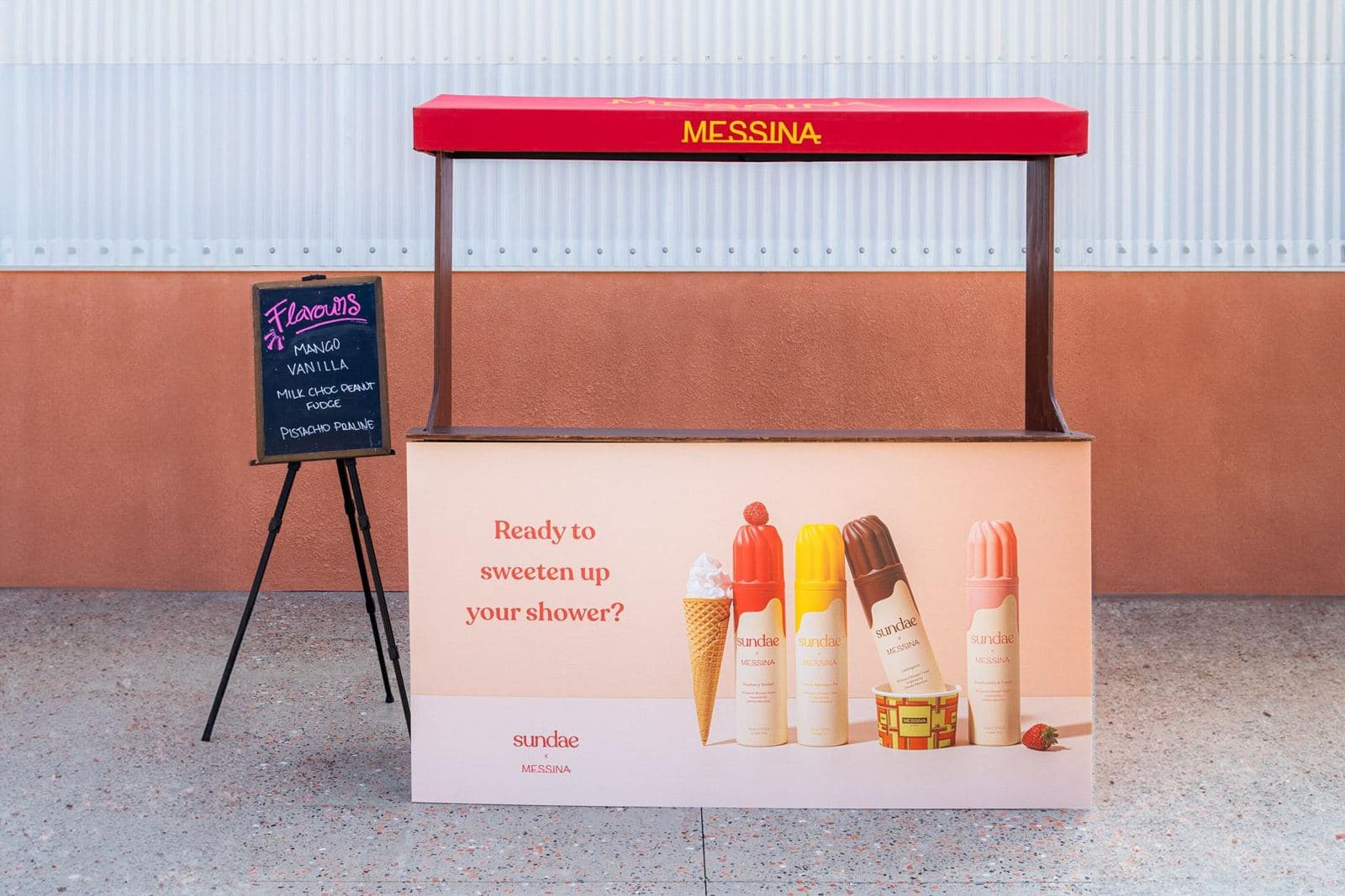 Large gelato stand with a pink panel and a chalkboard flavour board