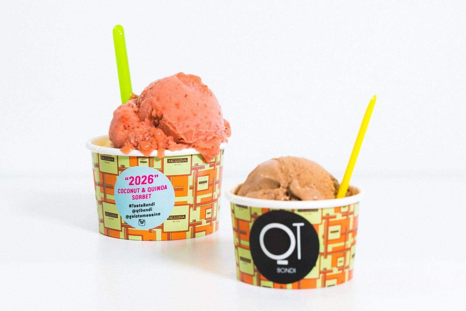 Two gelato cups with round branded stickers on them